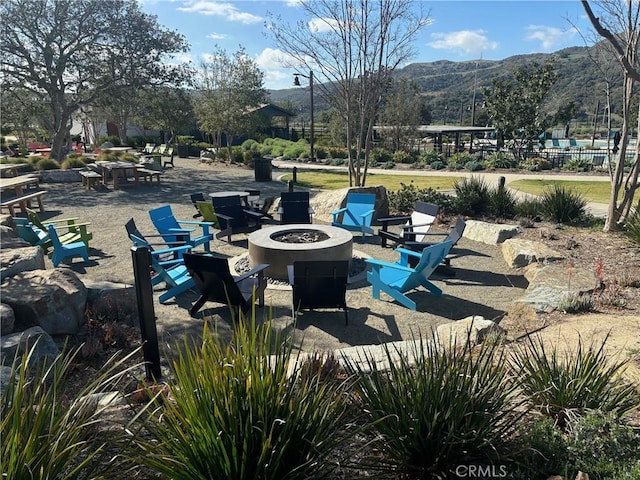 view of patio / terrace featuring a fire pit and a mountain view