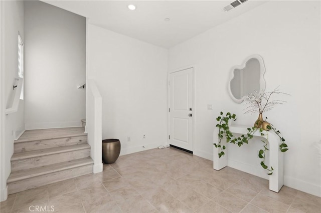 foyer featuring recessed lighting, visible vents, stairway, and baseboards