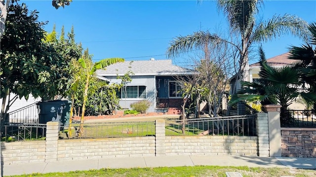 view of front of house featuring a fenced front yard and stucco siding