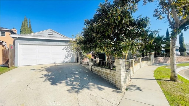 view of front of home with fence, driveway, and stucco siding