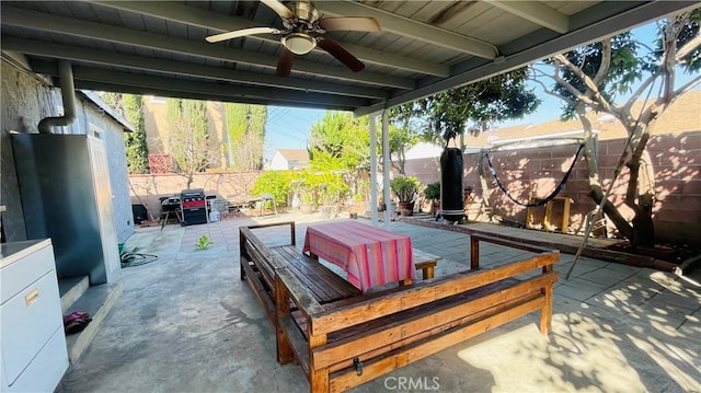 view of patio with outdoor dining area, a fenced backyard, and ceiling fan