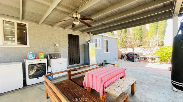 view of patio / terrace featuring ceiling fan, separate washer and dryer, and fence