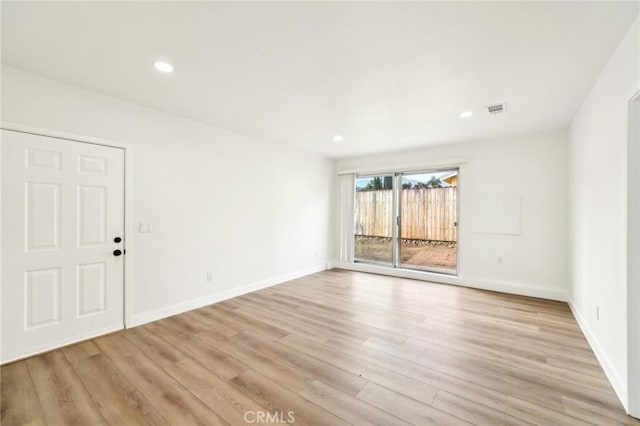 unfurnished room featuring light wood-style floors, baseboards, visible vents, and recessed lighting