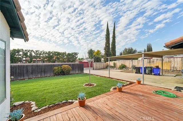 view of yard featuring a patio area, a fenced backyard, and a wooden deck