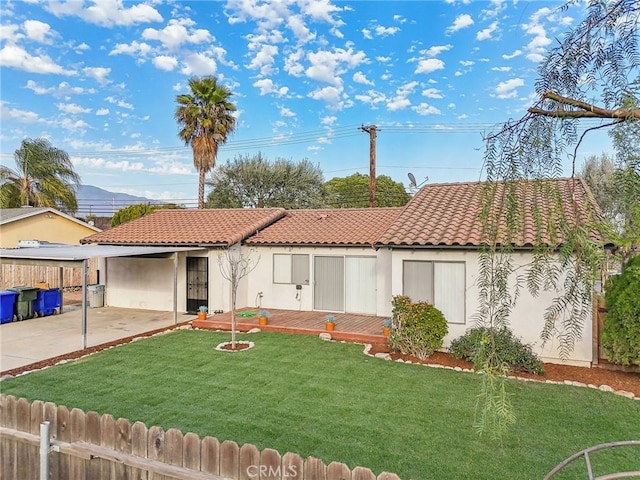 mediterranean / spanish-style home featuring a tiled roof, a front yard, fence, and stucco siding