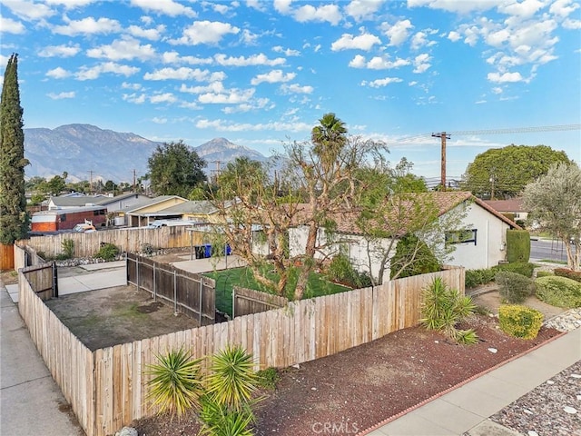 view of front of home featuring fence private yard and a mountain view