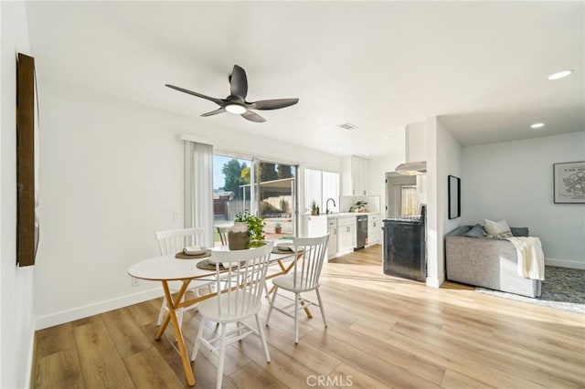 dining area with light wood-style floors, recessed lighting, and baseboards