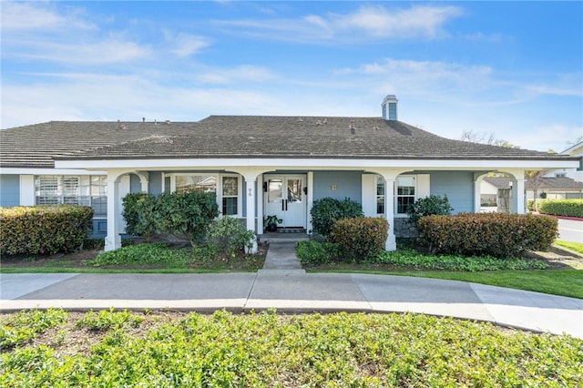 single story home featuring a chimney