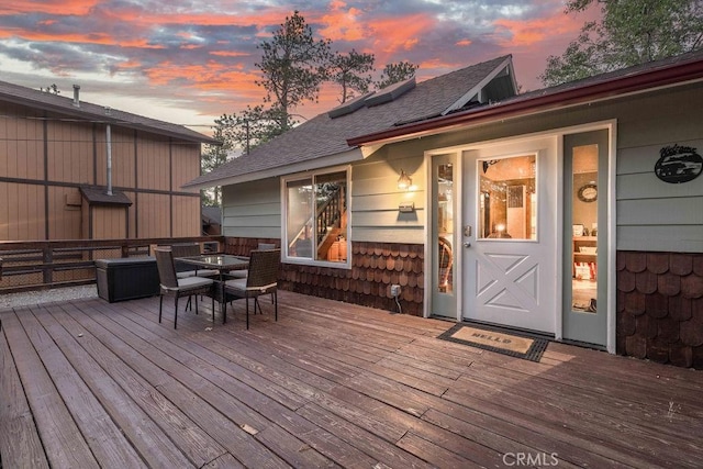 wooden terrace with outdoor dining area