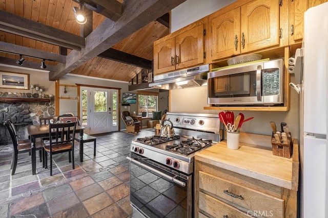 kitchen featuring wooden ceiling, appliances with stainless steel finishes, light countertops, stone tile flooring, and under cabinet range hood