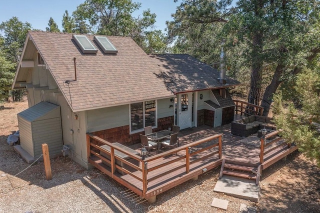 view of front facade featuring an outdoor hangout area, roof with shingles, and a wooden deck