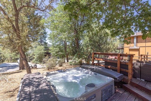 wooden deck with an outdoor hot tub