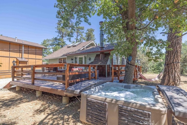 wooden deck with a hot tub