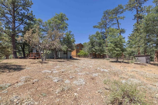 view of yard featuring fence and a wooden deck