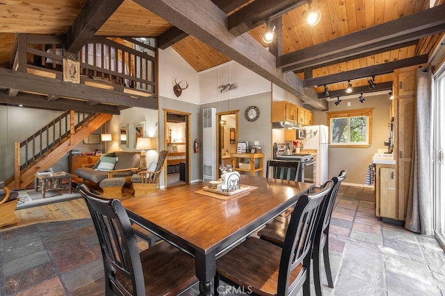 dining space featuring wooden ceiling, stone tile floors, baseboards, stairway, and beam ceiling