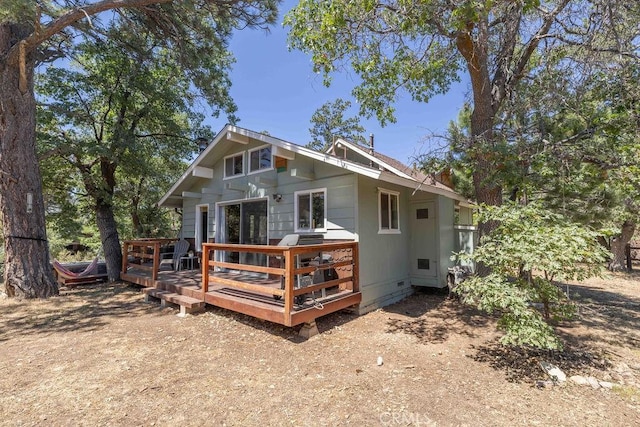 exterior space featuring crawl space and a wooden deck