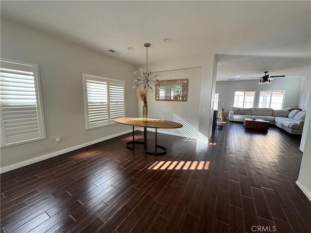 unfurnished dining area with visible vents, dark wood finished floors, baseboards, and ceiling fan