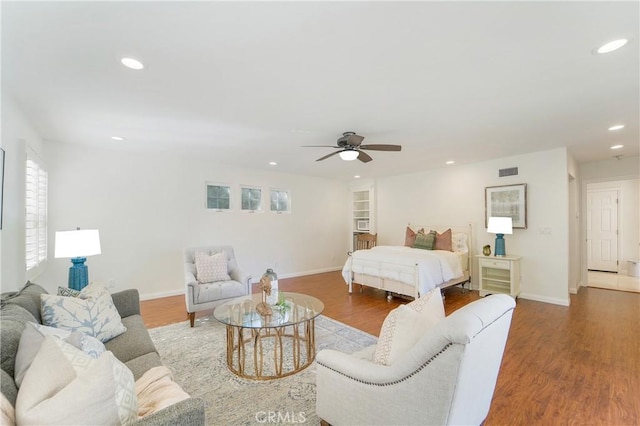 bedroom featuring a ceiling fan, visible vents, wood finished floors, baseboards, and recessed lighting