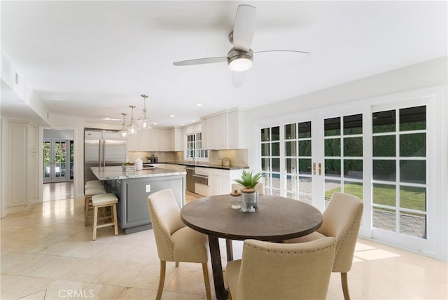 dining room featuring ceiling fan with notable chandelier, recessed lighting, french doors, and light tile patterned floors