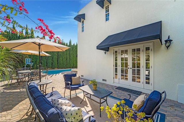 view of patio / terrace featuring outdoor dining space, an outdoor living space, french doors, and an outdoor pool