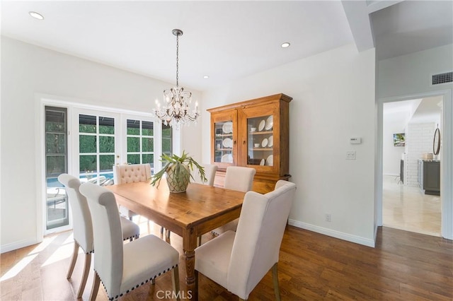 dining room with visible vents, baseboards, recessed lighting, an inviting chandelier, and wood finished floors