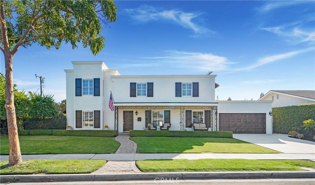 view of front facade with a front yard, driveway, a porch, an attached garage, and stucco siding