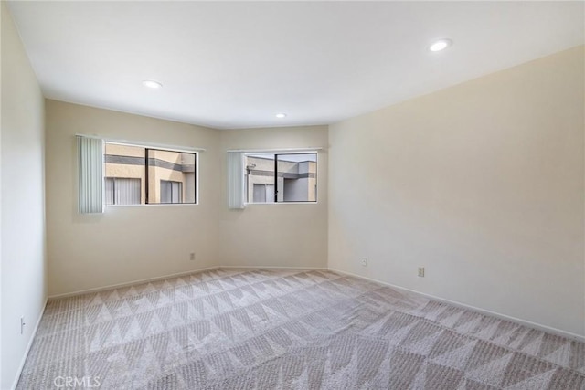 carpeted spare room with recessed lighting and baseboards