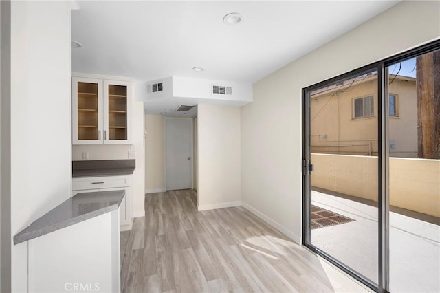 interior space with light wood-style floors, baseboards, visible vents, and recessed lighting