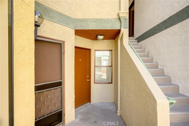 property entrance with stucco siding