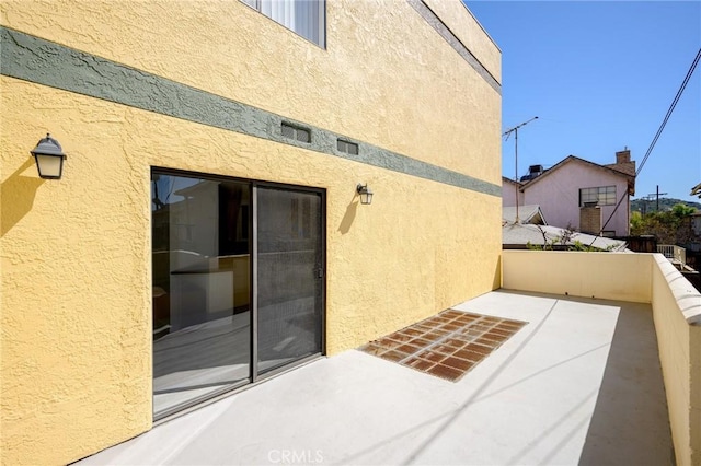 exterior space featuring a balcony and stucco siding