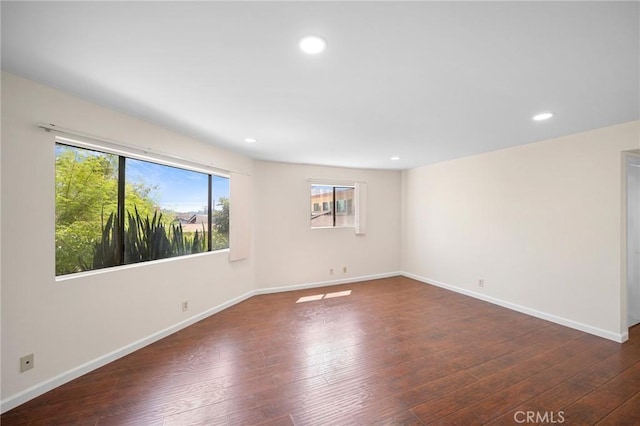 empty room with recessed lighting, baseboards, and hardwood / wood-style flooring