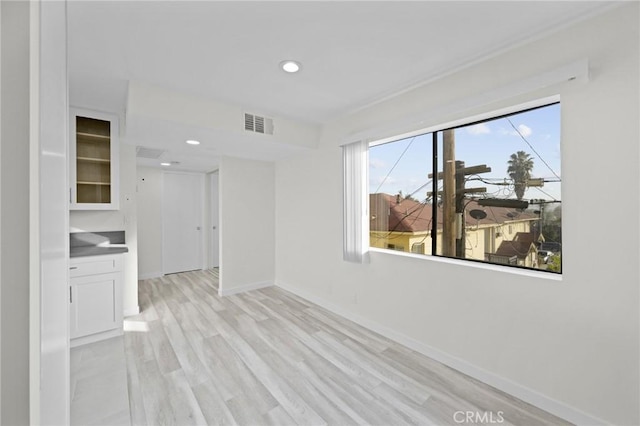 interior space with baseboards, recessed lighting, visible vents, and light wood-style floors