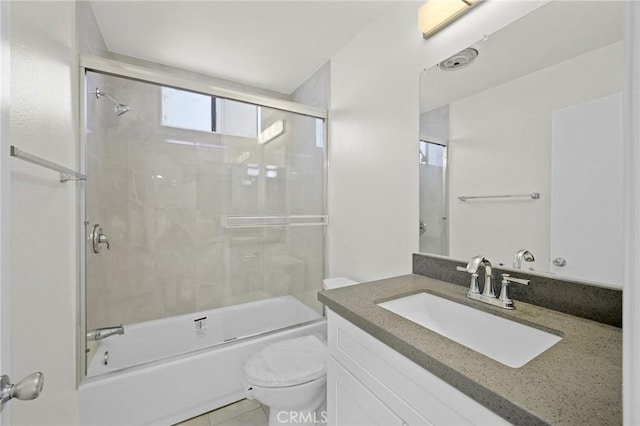 full bathroom featuring combined bath / shower with glass door, vanity, and toilet