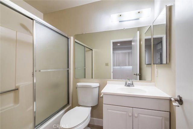 full bathroom featuring enclosed tub / shower combo, vanity, and toilet