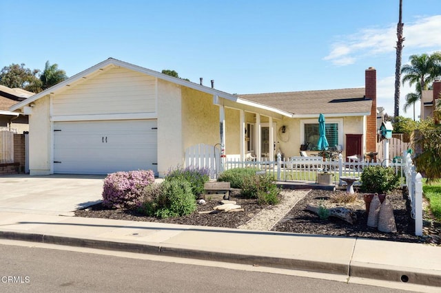 ranch-style home with a fenced front yard, an attached garage, concrete driveway, roof with shingles, and stucco siding