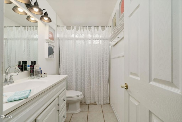 full bathroom with curtained shower, vanity, toilet, and tile patterned floors