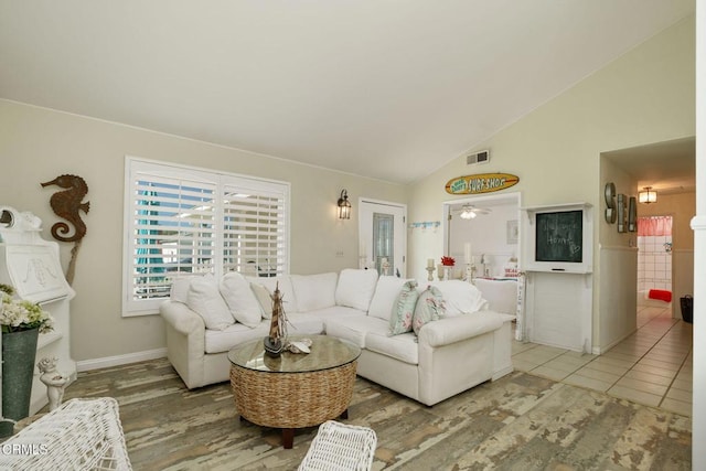 living area with lofted ceiling and visible vents