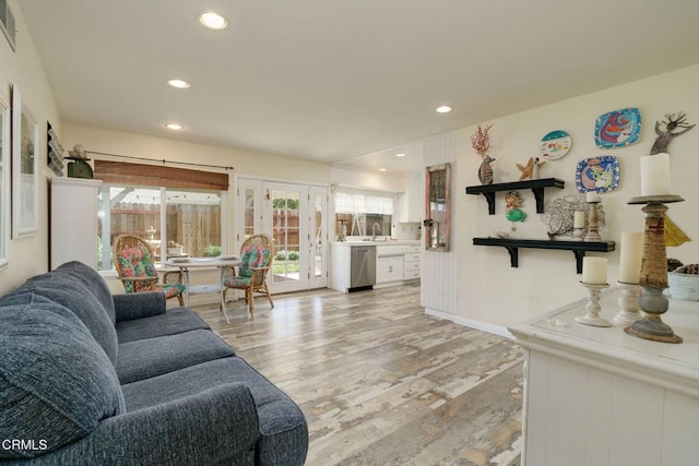 living room with baseboards, recessed lighting, visible vents, and light wood-style floors