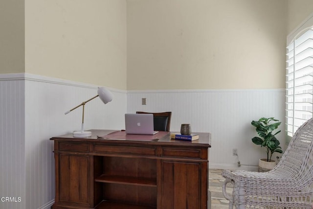 home office featuring a wainscoted wall and wood finished floors