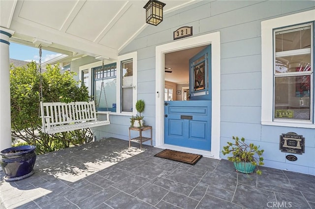 view of exterior entry featuring a porch