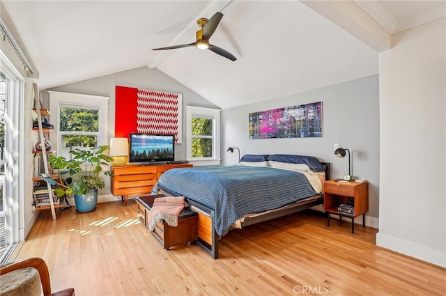 bedroom featuring a ceiling fan, lofted ceiling with beams, baseboards, and wood finished floors