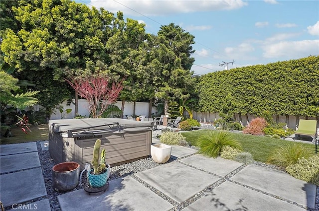 view of patio / terrace featuring a fenced backyard and a hot tub