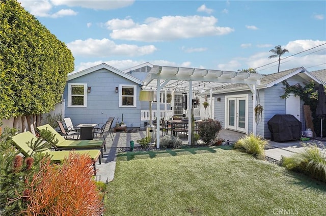 rear view of property with fence, french doors, a lawn, a pergola, and a patio area