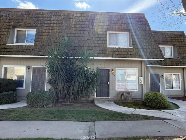 townhome / multi-family property with mansard roof