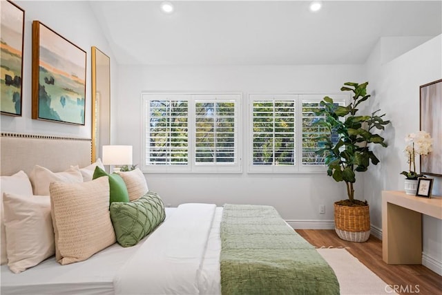 bedroom with vaulted ceiling, baseboards, wood finished floors, and recessed lighting