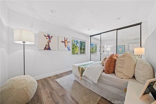 bedroom featuring baseboards and wood finished floors