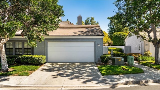 garage with concrete driveway and central air condition unit