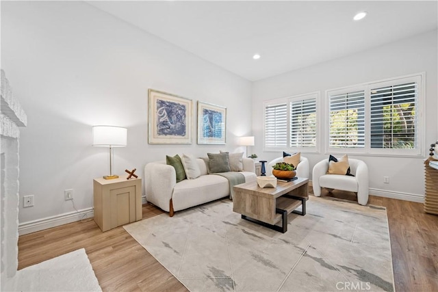 living area featuring recessed lighting, baseboards, and wood finished floors