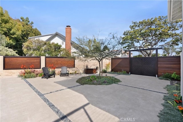 view of patio / terrace featuring fence private yard and a gate