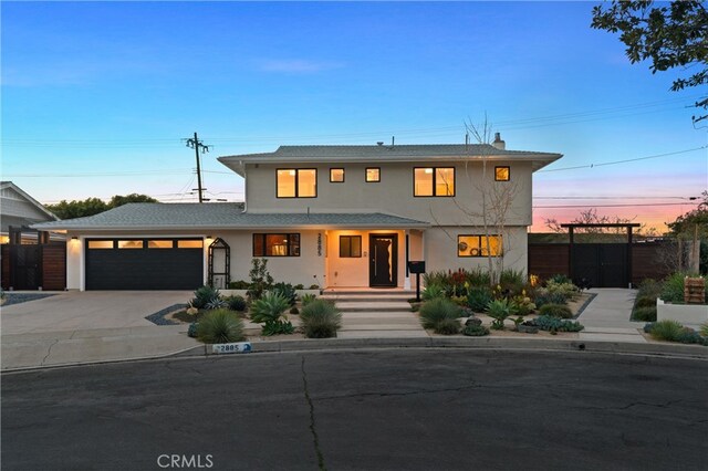 2885 Europa Dr, Costa Mesa, CA 92626 - view of front of house featuring fence, driveway, an attached garage, covered porch, and stucco siding